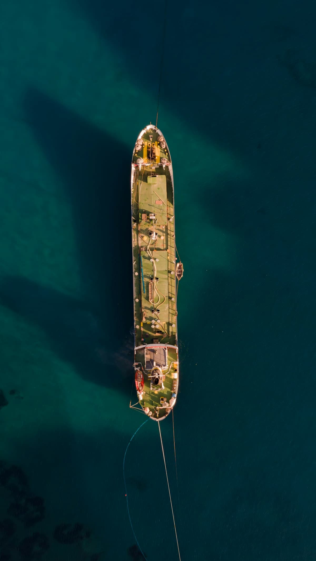 Aerial view of a shipwreck in clear water — the subject of heritage surveys.