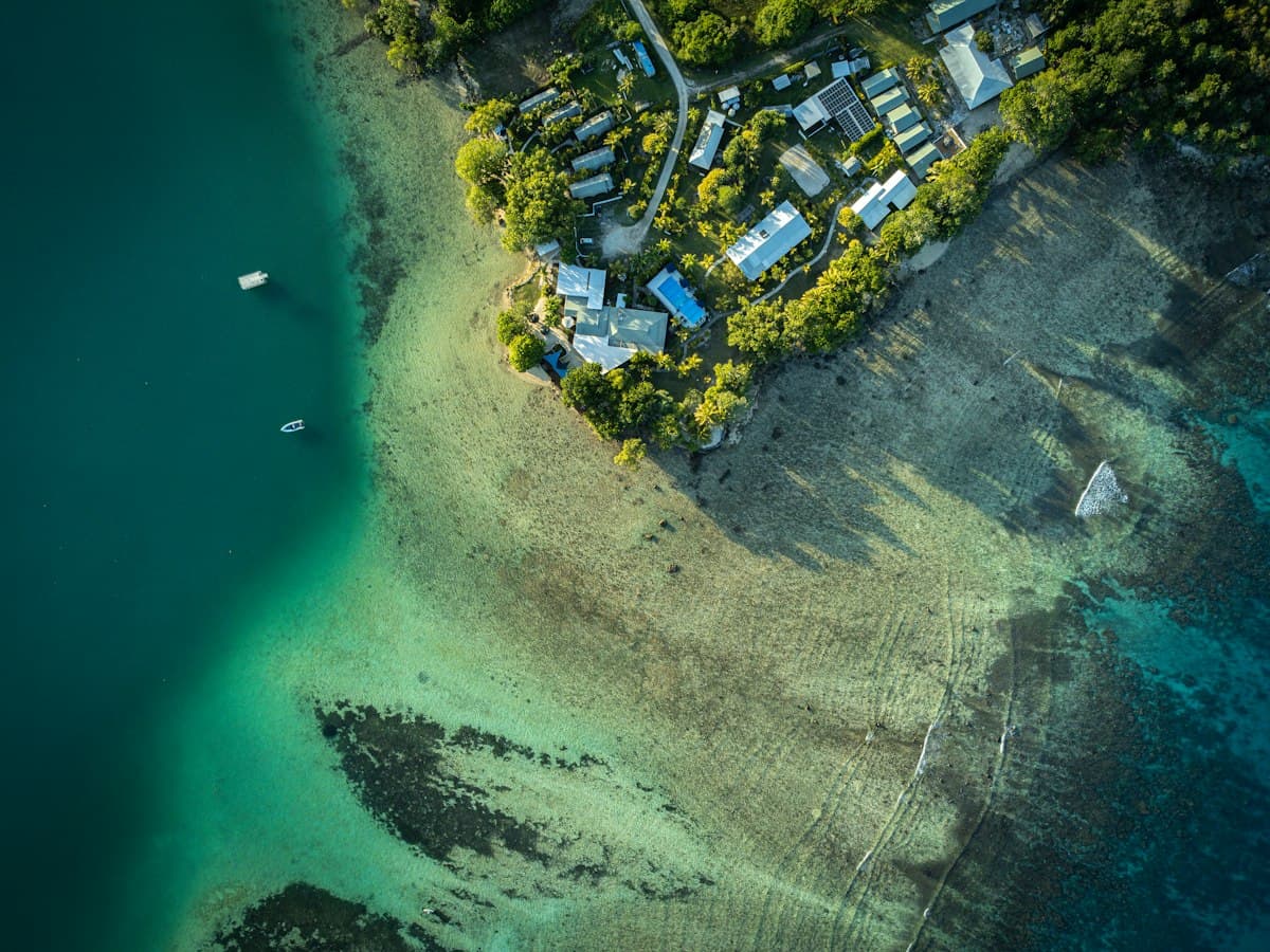Aerial view of a Pacific island coastal village.